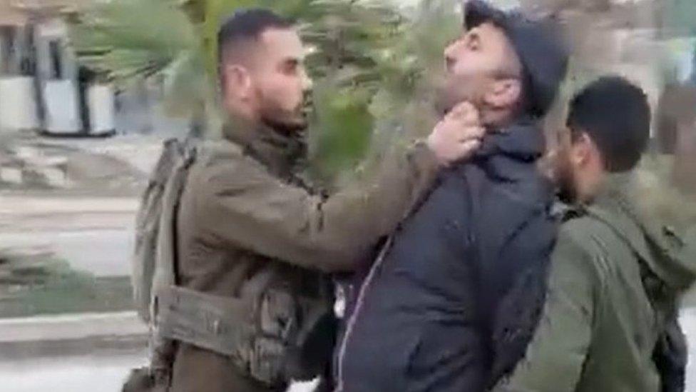 Screengrab of video from New Yorker journalist Lawrence Wright showing an Israeli soldier assaulting Palestinian activist Issa Amro in Hebron, in the occupied West Bank (13 February 2023)