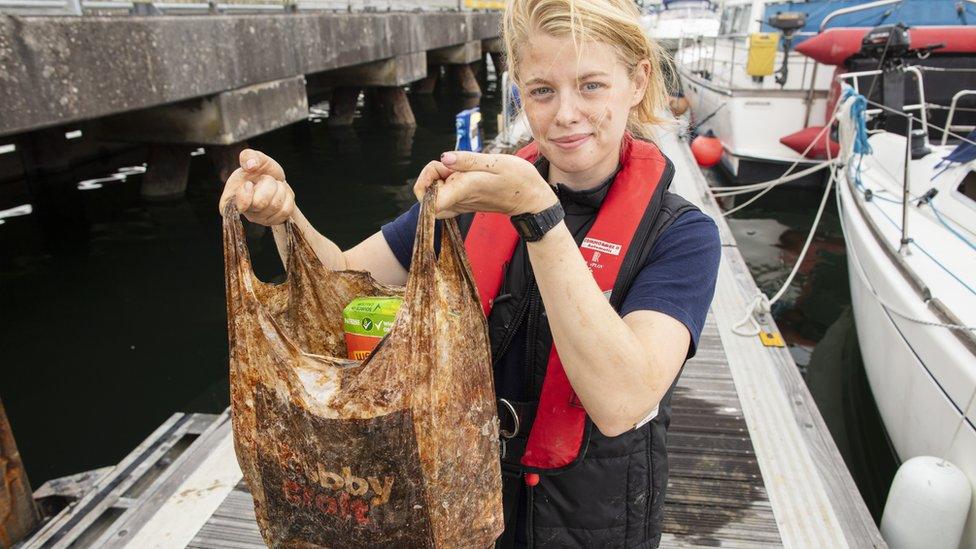 Imogen Napper with a plastic bag from the soil