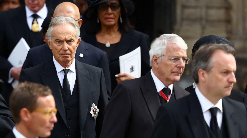 British former prime ministers Tony Blair and John Major leave Westminster Abbey after the service