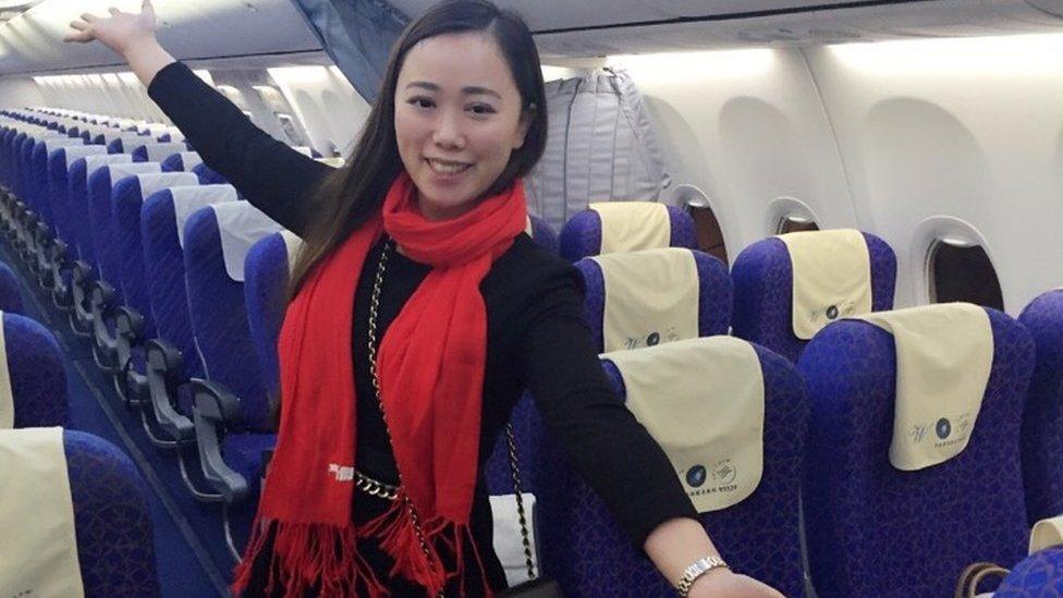 Ms Zhang poses in the empty cabin