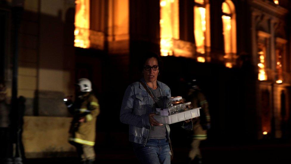 A worker rescues items during a fire at the National Museum of Brazil in Rio de Janeiro, Brazil on 2 September 2018