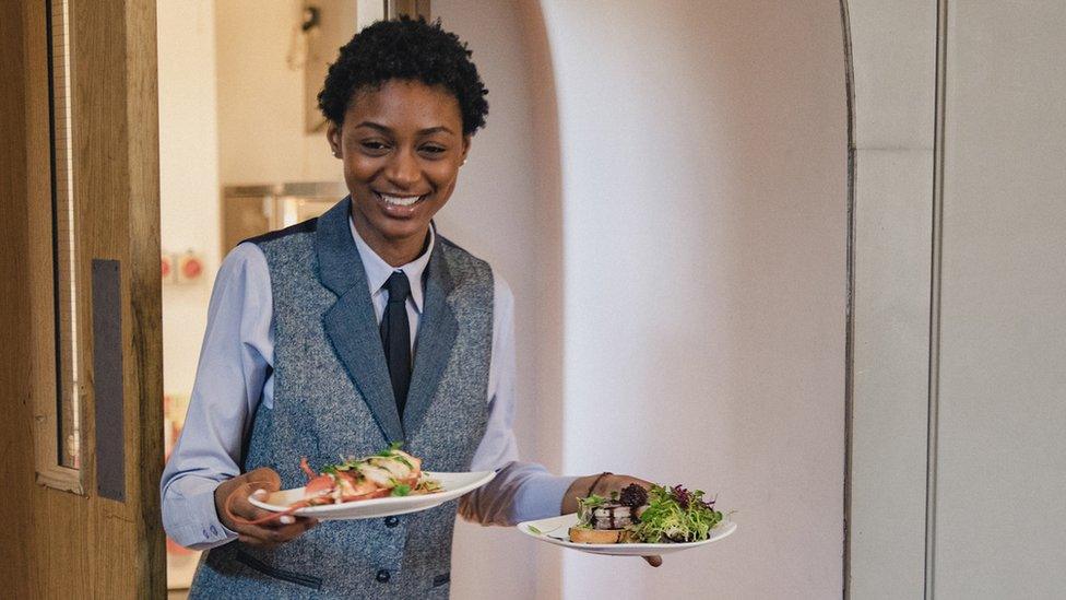 Young woman holding plates