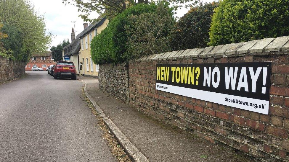 Protest signs against the scheme