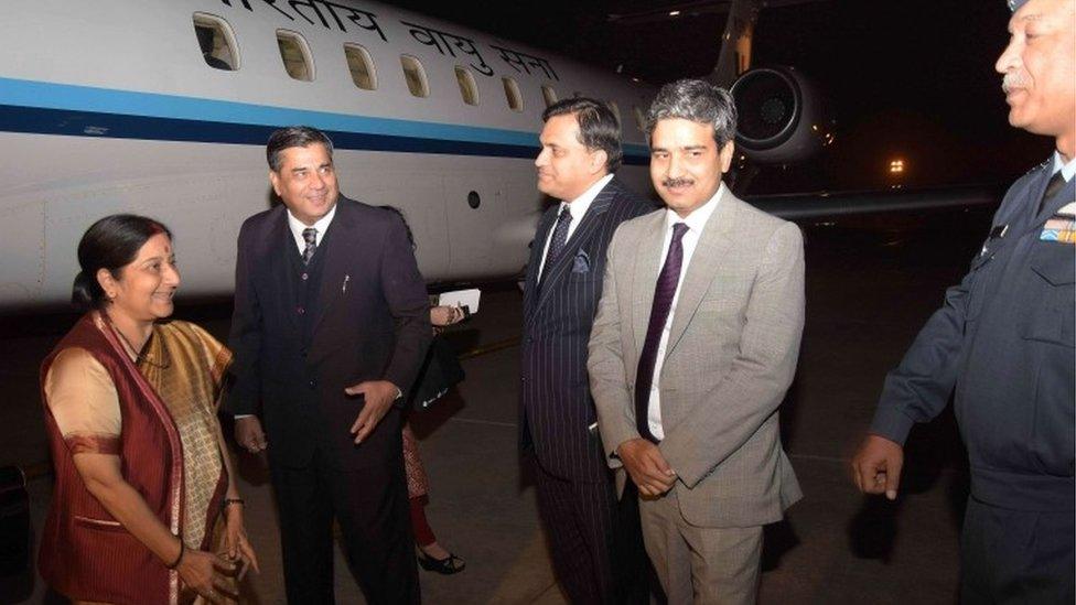 Indian Foreign Minister Sushma Swaraj (L) is greeted by Indian and Pakistani officials upon her arrival at the military Nur Khan airbase in Rawalpindi on December 8, 2015