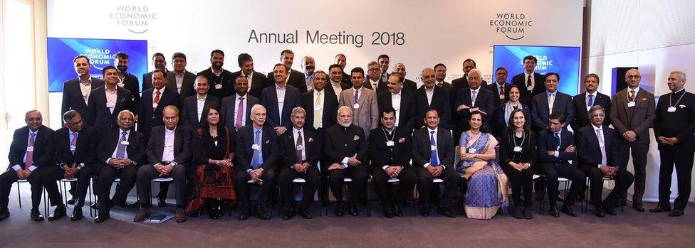 This handout photo released by India's Press Information Bureau on January 23, 2018 shows Indian Prime Minister Narendra Modi (bottom row, C) posing for a group photograph with Indian chief executives, including billionaire jeweller Nirav Modi