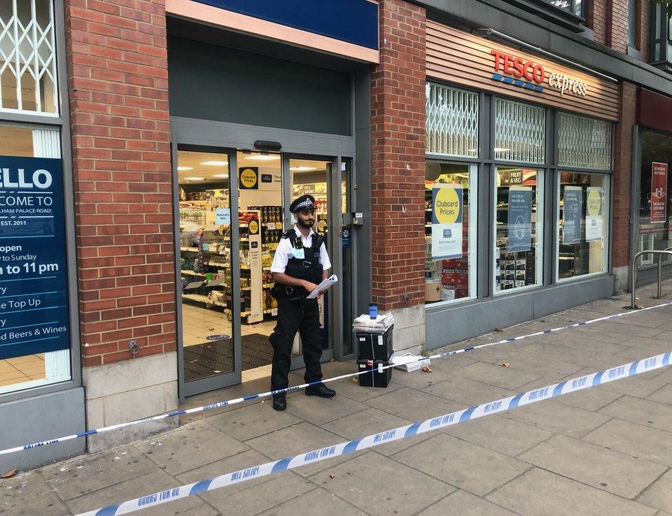 Policeman at door Tesco Express