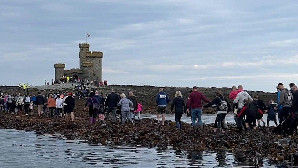 People walking to the Tower of Refuge