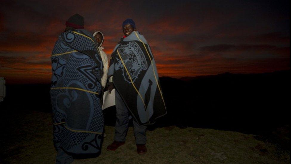 Basotho people huddle up in blankets outside Maseru on 26 May 2012