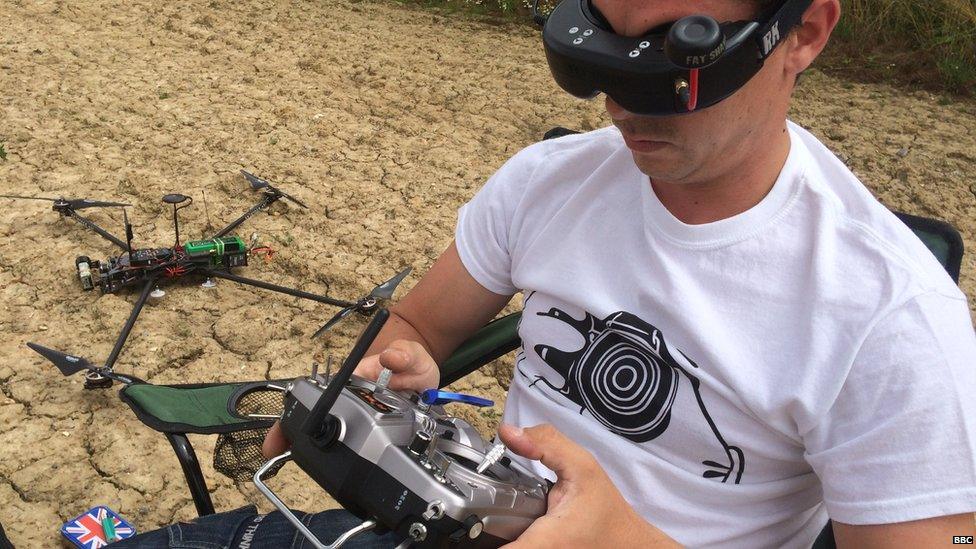 Lee controlling a drone and viewing the video images it sends on his goggles through the device's 'eyes', it's cameras