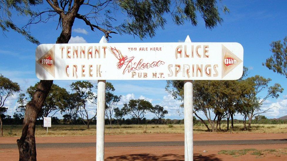 A road sign pointing directions to Tennant Creek and Alice Springs