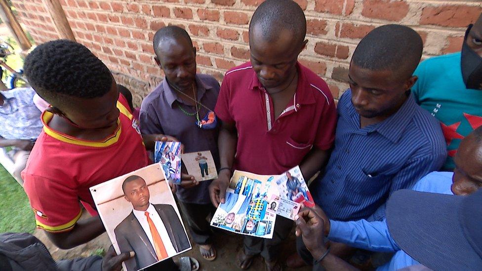 People holding photographs