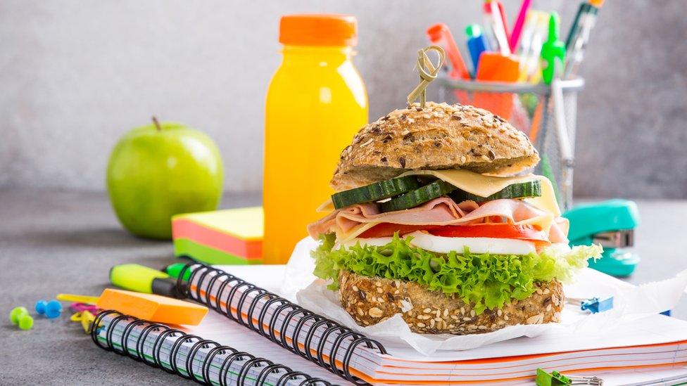 A lunch on a pile of notepads, back to school