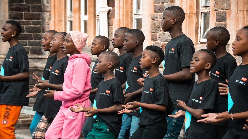 A choir of Zulu children singing and dancing