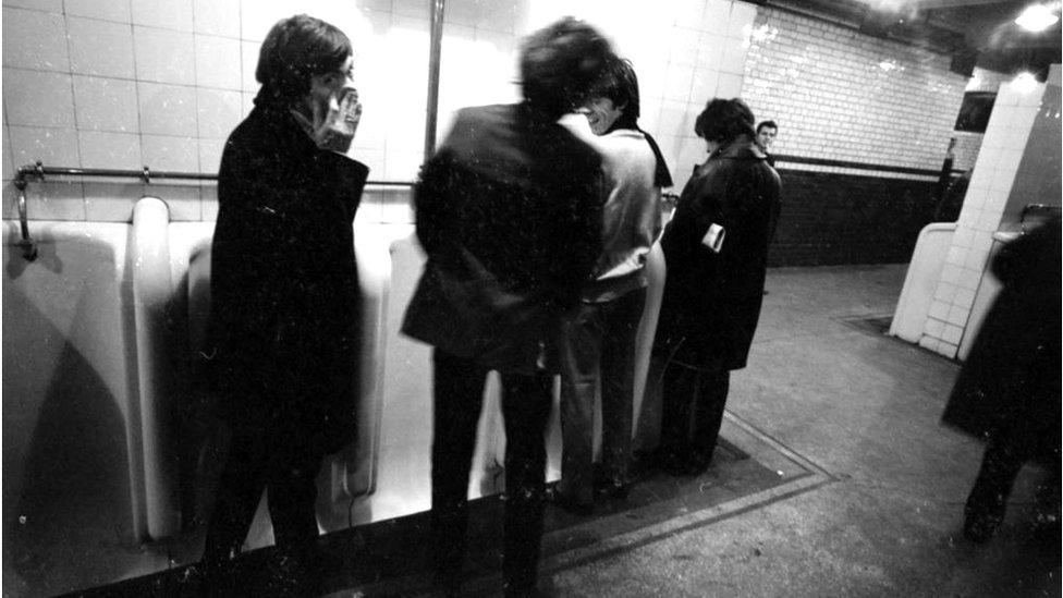 View of members of British Rock group the Rolling Stones as they pose in the public toilets at Victoria Station, London, England, October 11, 1964. They were en route to a gig in Brighton. Pictured are, from left, Charlie Watts (1941 - 2021), Mick Jagger, Keith Richards, and Bill Wyman. (Photo by Mark and Colleen Hayward/Getty Images)