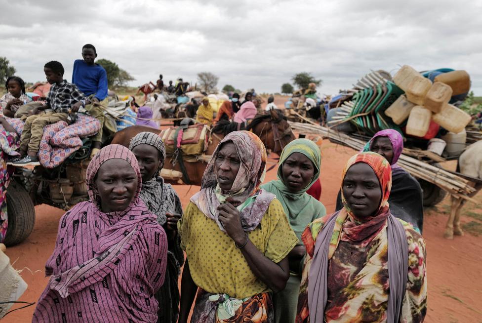 Sudanese women, who fled the conflict in Murnei in Sudan's Darfur region, wait beside their belongings to be registered by UNHCR upon crossing the border between Sudan and Chad, in Adre, Chad July 26, 2023.