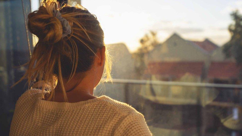 Woman looking out of window