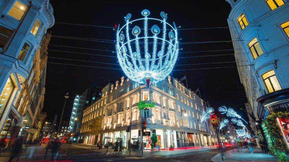 2020 picture of Fenwick lit up at night below Christmas street lights.