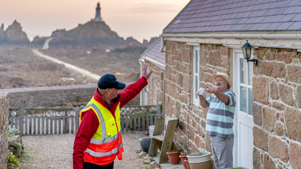 A postman waving