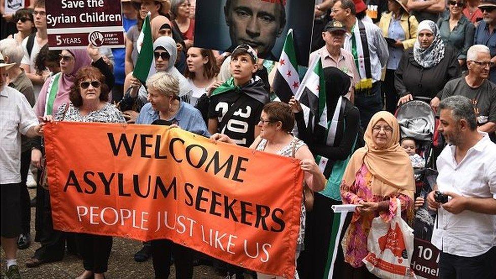 Protesters gather in support of refugees and asylum seekers in Sydney on October 11, 2015.