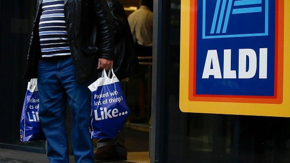 A man leaving an Aldi supermarket