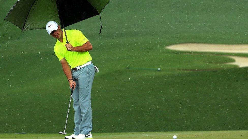 Rorly McIlroy golfing in the rain.