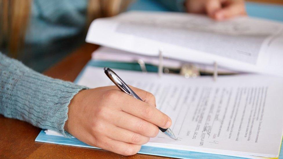 Person marking a paper