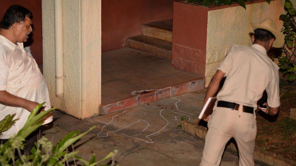 Police officials investigate the crime scene at the house of 55-year-old Gauri Lankesh