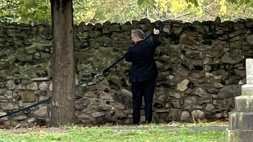 The banner's rope on the other side of the church wall