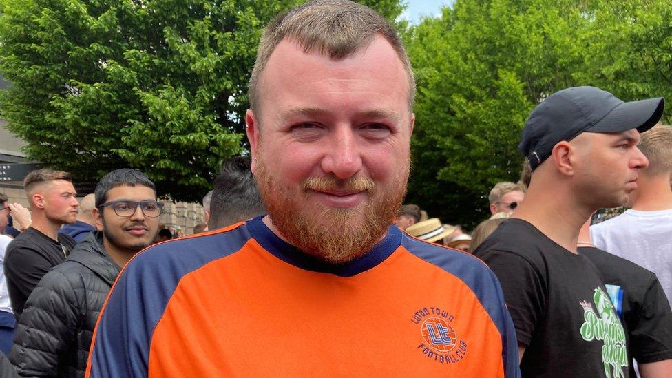 Matt Bell in Luton town centre wearing a Luton Town shirt