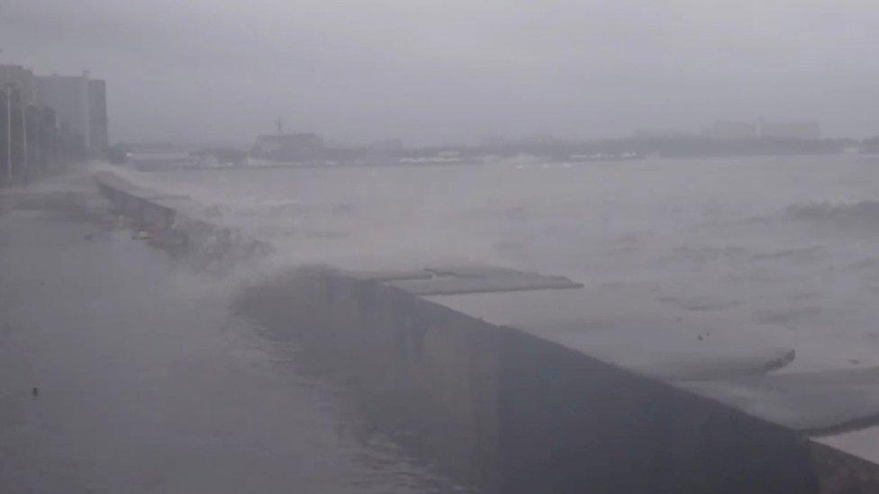 water splashes over a wall on Roxas Blvd in Manila