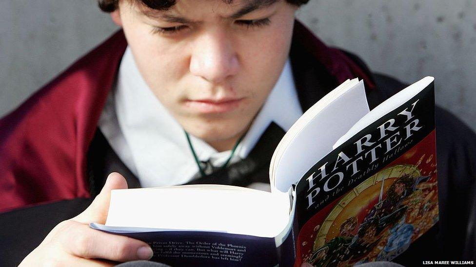 boy reading harry potter book