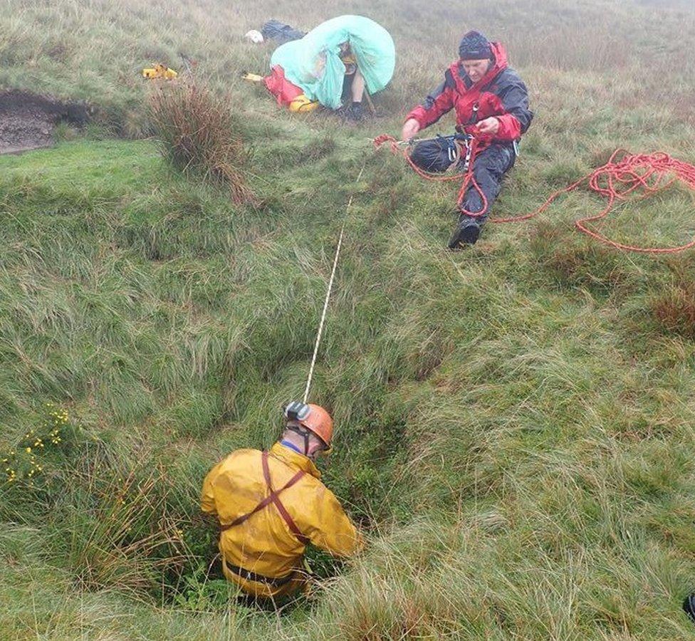 Rescuer being lowered into the hole