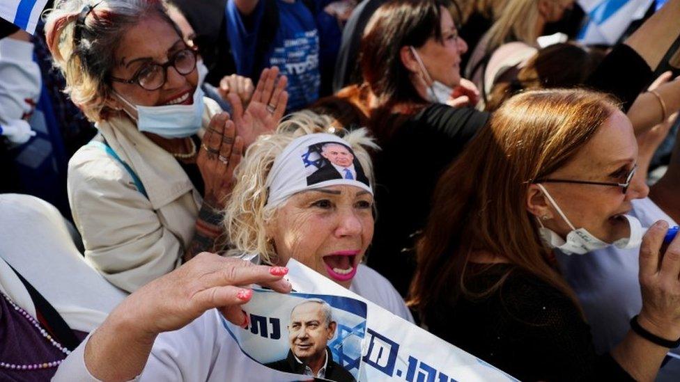 A supporter of Israeli Prime Minister Benjamin Netanyahu shouts slogans during a rally as his corruption trial resumes in Jerusalem (5 April 2021)