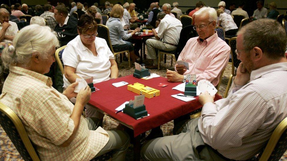 Two couples playing bridge