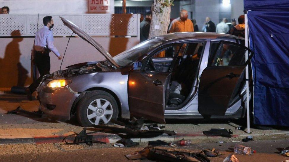 Israeli security forces gather at the site of an attack that left two people dead in the northern city of Hadera