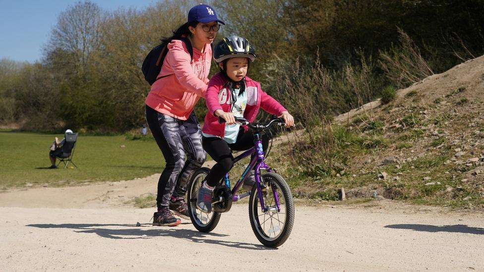 Sue and her daughter on a bike