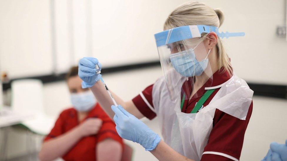 A nurse preparing a Covid-19 vaccine