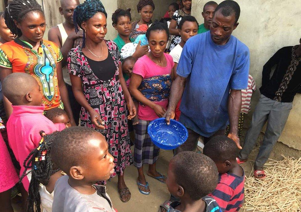 A group picture of displaced women and children together in a village