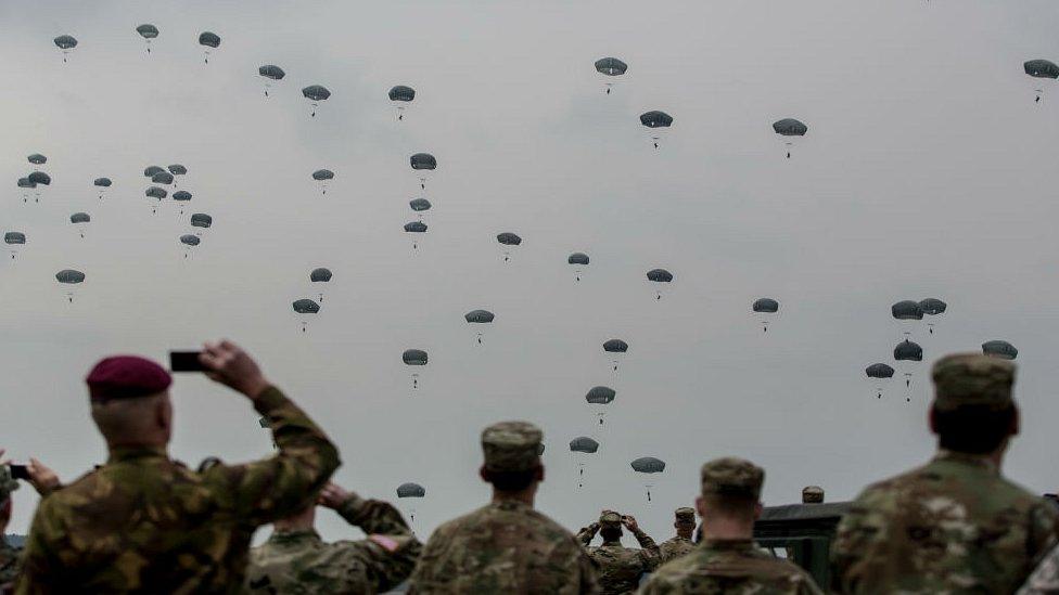 Soldiers watch US, UK and Italian paratroopers during training jump as part of Saber Junction 16 military exercises near Hohenfels Training Area near Grafenwoehr, Germany. 12 April 2016