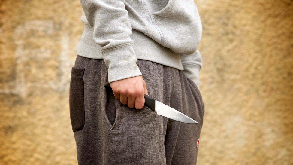 Stock photo of a model holding a knife