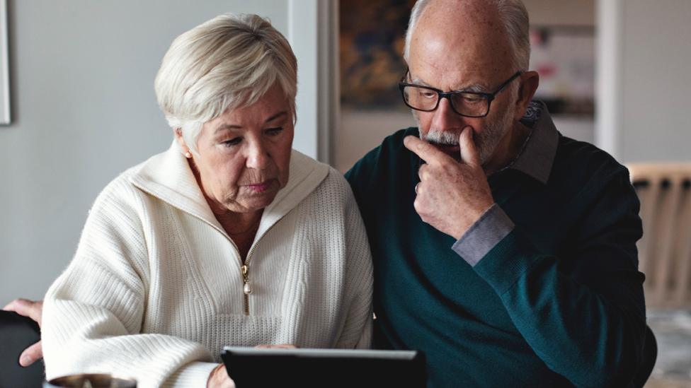 Stock image of an older couple indoors