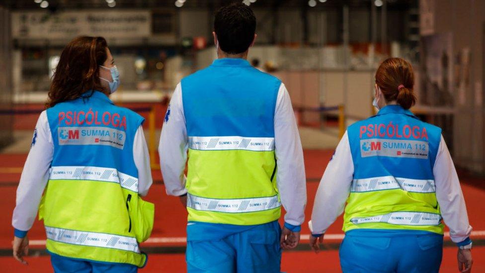 Health workers pictured from behind in Madrid, Spain.