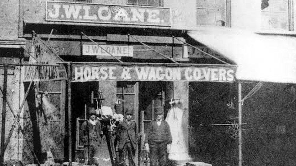 Black and white photograph showing the first Loane Bros storefront in the 1800s