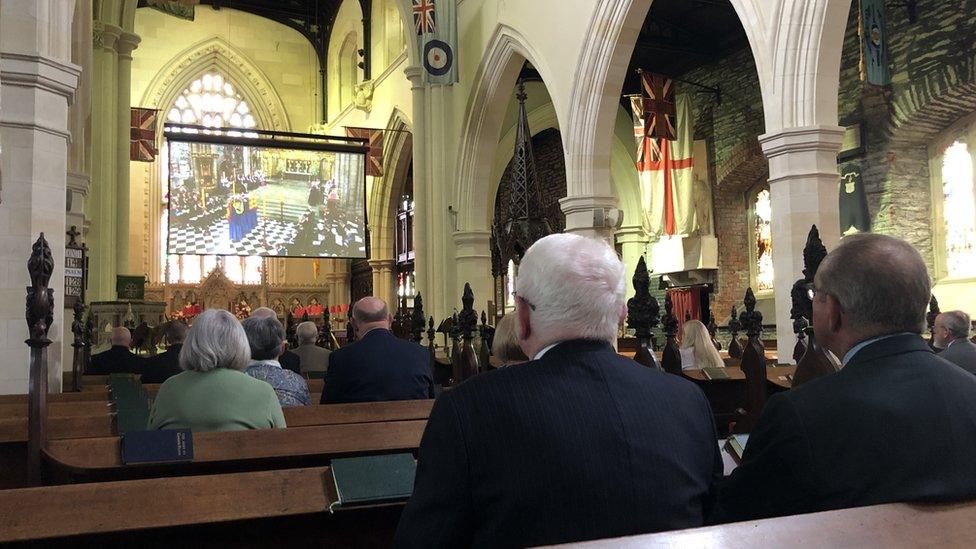 Mourners gather inside at St Columb's Church of Ireland Cathedral