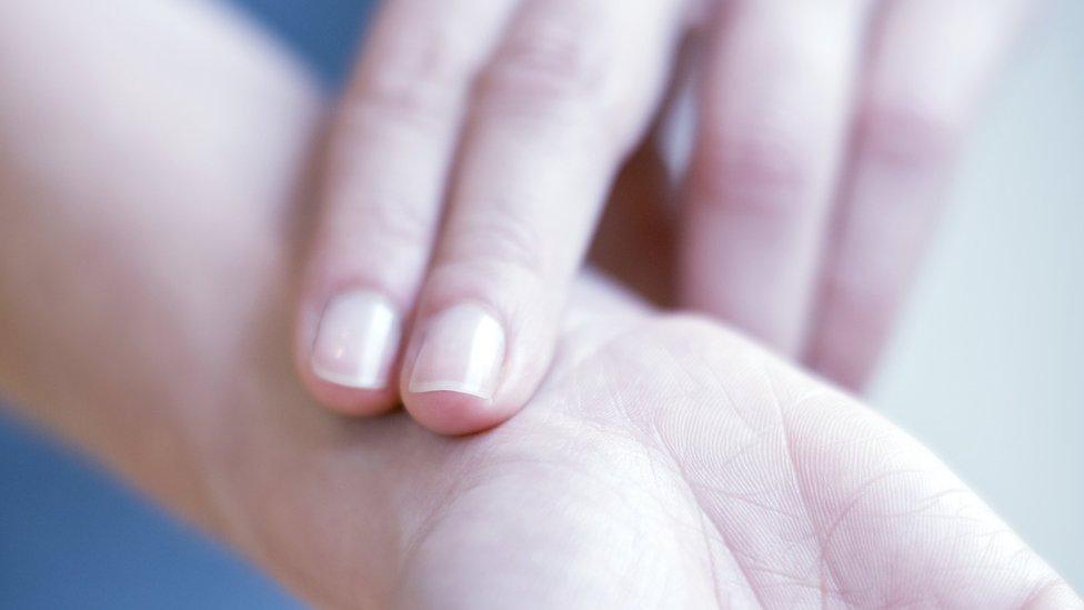 woman checking her own pulse