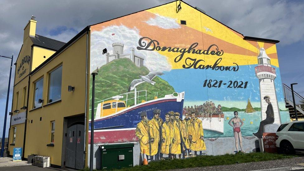 A colourful mural depicting Donaghadee Harbour on a gable wall in the town