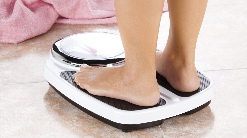 Woman standing on scales