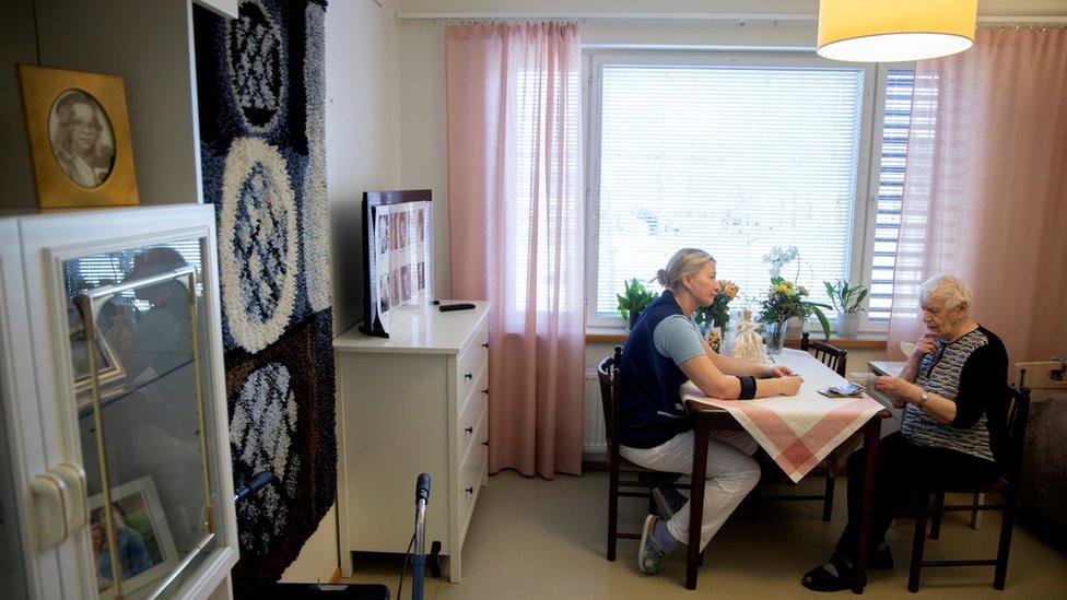 A nurse assists an elderly resident at the public care unit Heikanrinne in Forssa, Finland, 2 April 2019