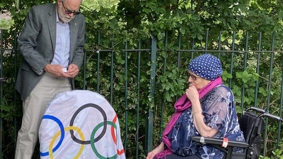 ceremony at a gravestone unveiling, with Vanessa in a wheelchair