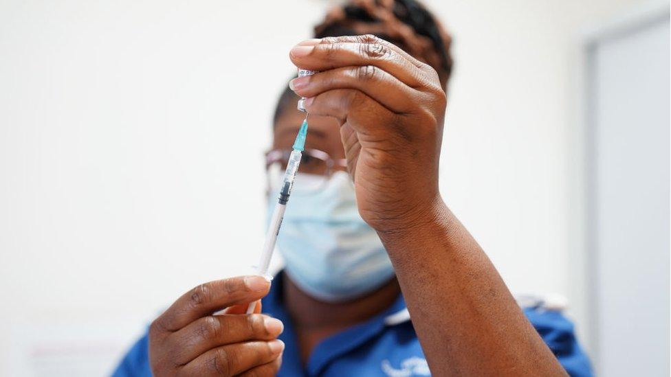 A nurse prepares a Covid vaccine during the spring booster campaign